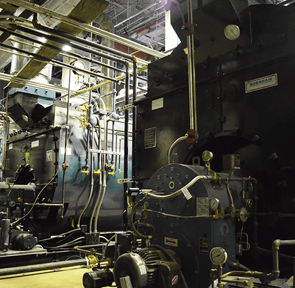 A large industrial building with many pipes and valves.