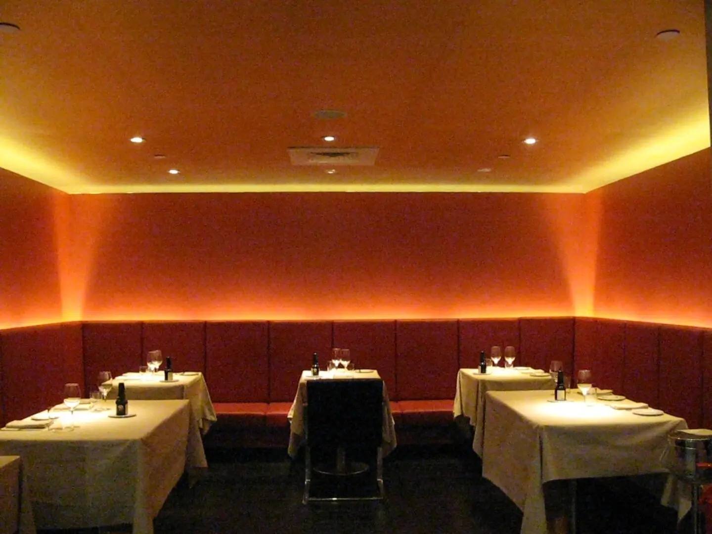 IMG_1597 A restaurant with three tables and two chairs.