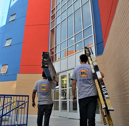 Two men are carrying ladders and a ladder.