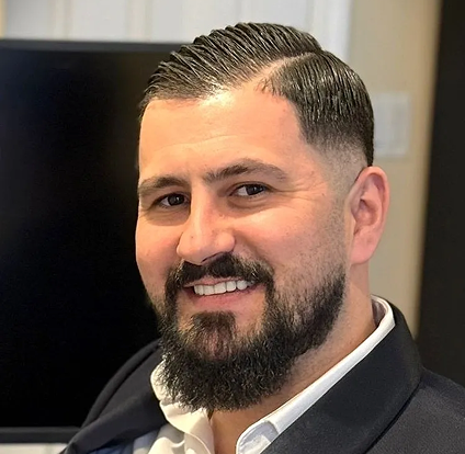 A man with a beard and mustache wearing a suit.