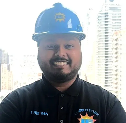 A man wearing a hard hat and smiling.
