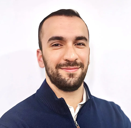A man with a beard and blue jacket