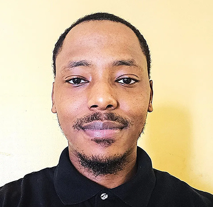 A man with a black shirt is smiling