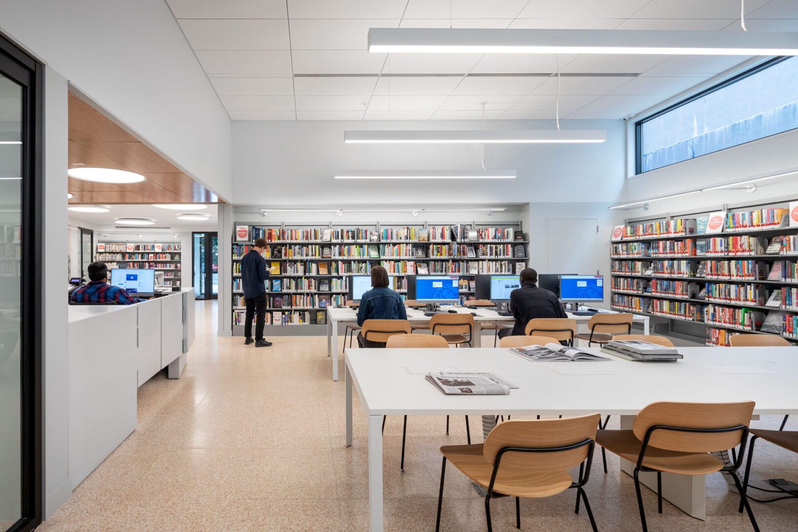 NYPL5 A library with people sitting at tables and computers.