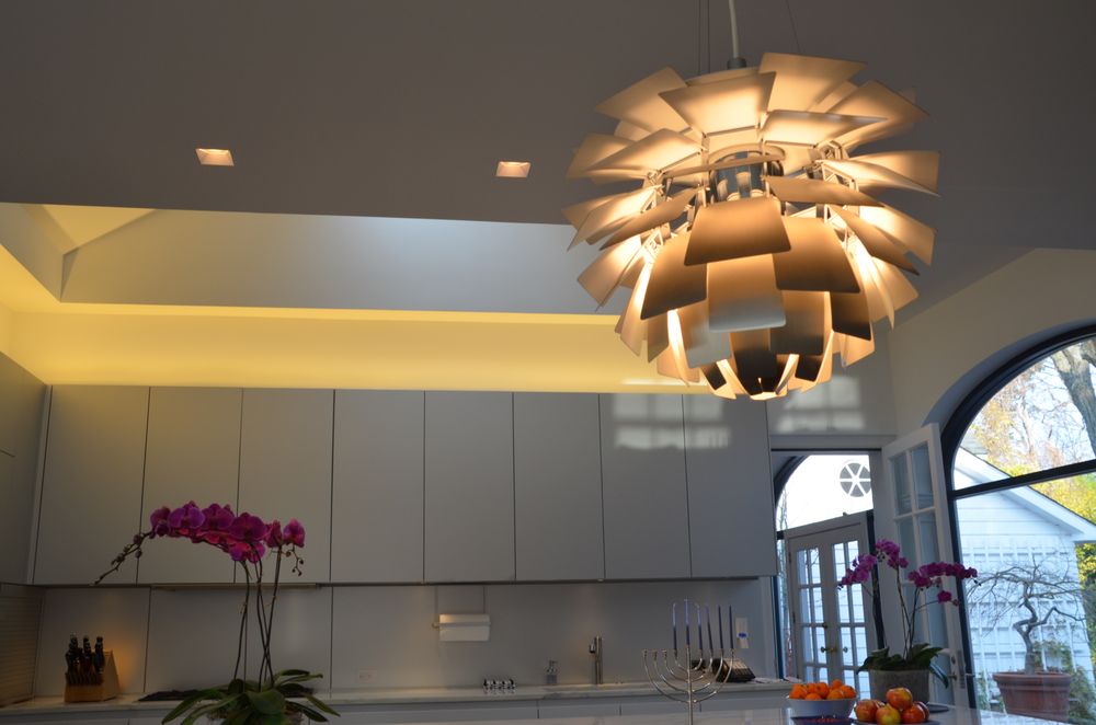 Res 2 A kitchen with white cabinets and a large light fixture.
